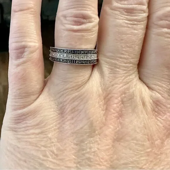 Sterling silver band with small diamond chips.